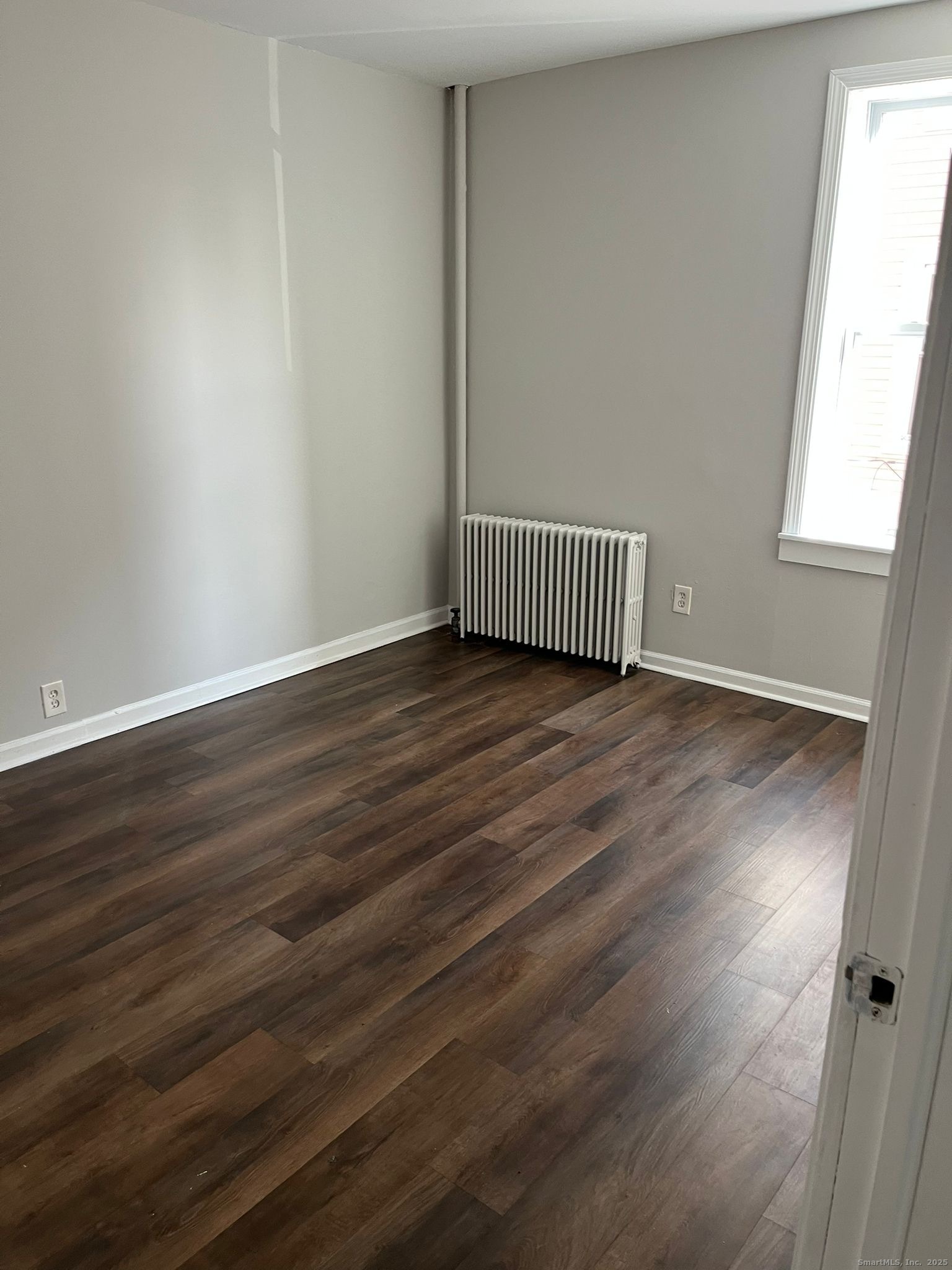 146 George Street, Unit 2 Bridgeport, CT 06604 - Photo 3 of 7 a view of a hallway with wooden floor and a window