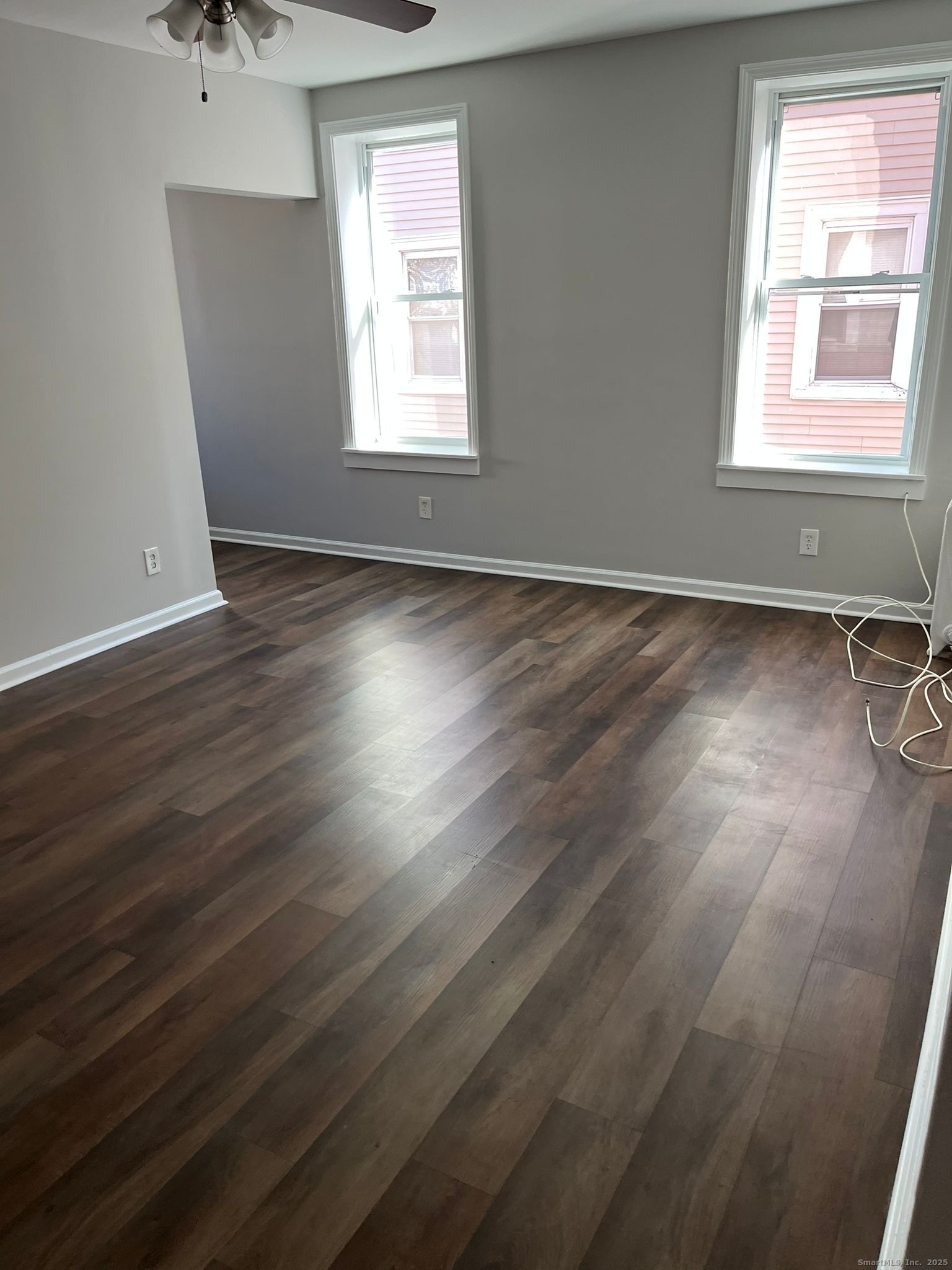 146 George Street, Unit 2 Bridgeport, CT 06604 - Photo 6 of 7 an empty room with wooden floor and windows