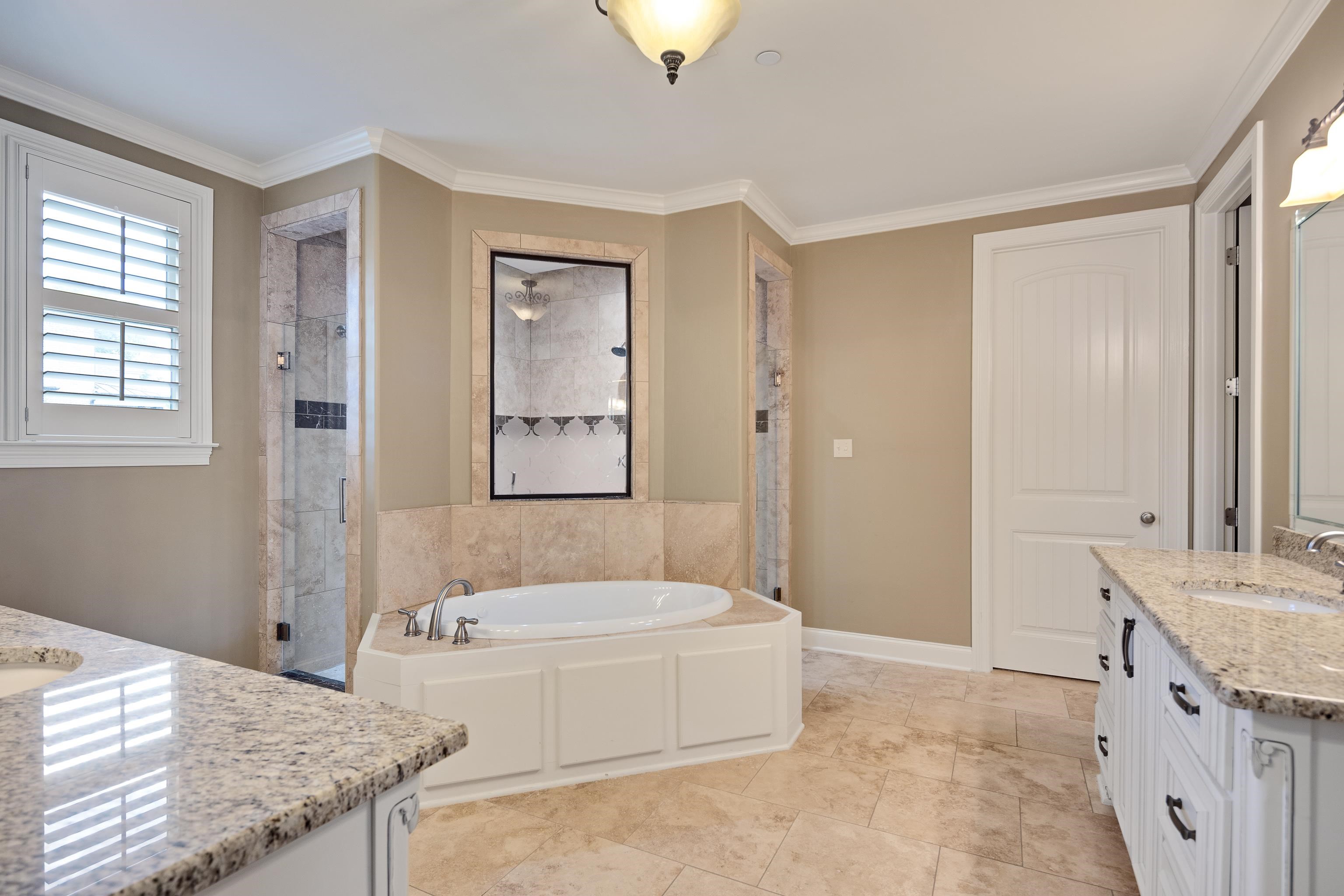 250 Ridgewood Drive Piperton, TN 38017 - Photo 12 of 36 a spacious bathroom with a granite countertop tub sink and mirror