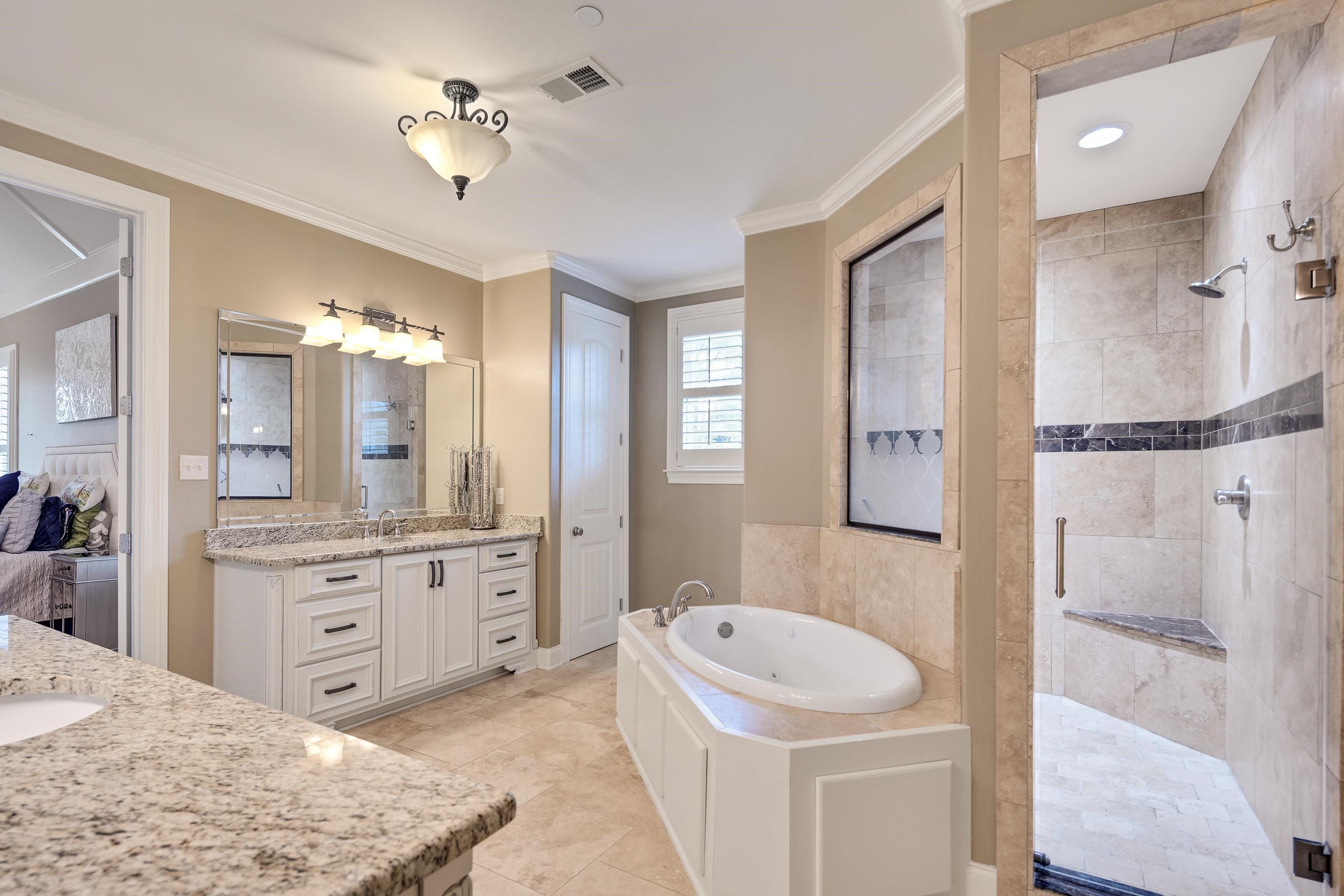 250 Ridgewood Drive Piperton, TN 38017 - Photo 13 of 36 a spacious bathroom with a granite countertop sink a toilet a mirror and shower