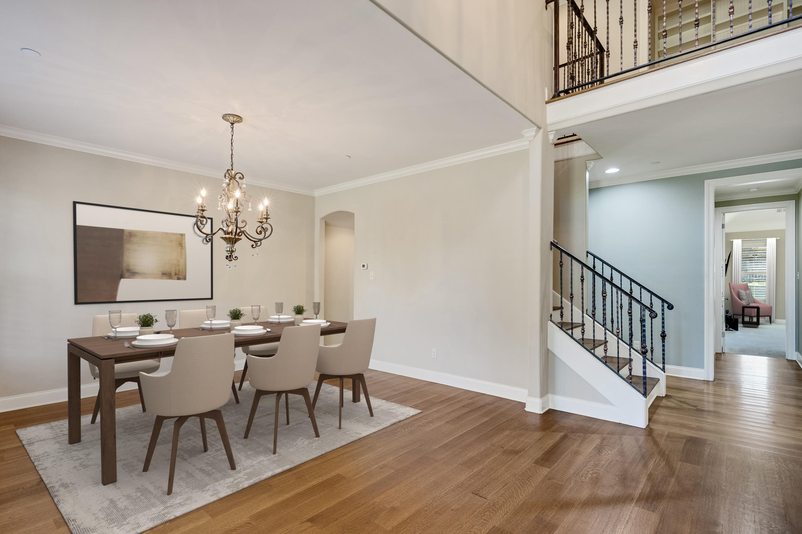 250 Ridgewood Drive Piperton, TN 38017 - Photo 4 of 36 a view of a dining room with furniture a chandelier and wooden floor