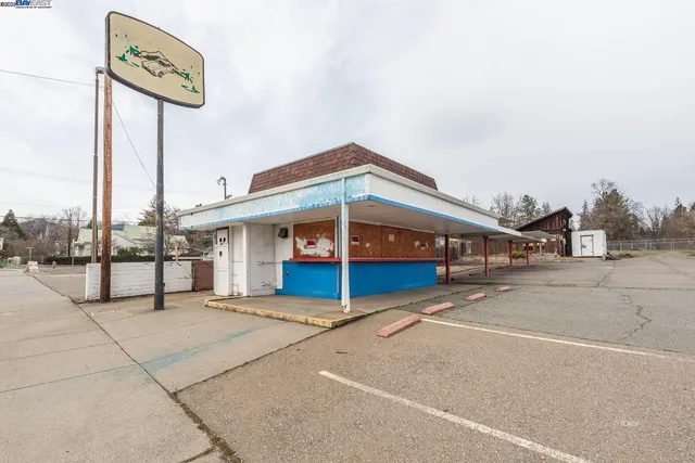 a blue sign that is on the side of a road