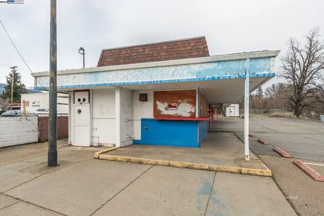 a front view of a building with parking
