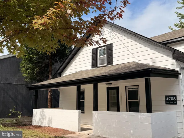 a view of house with a tree front of house