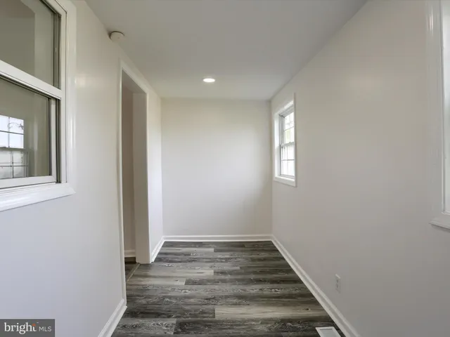a view of a room with wooden floor and window