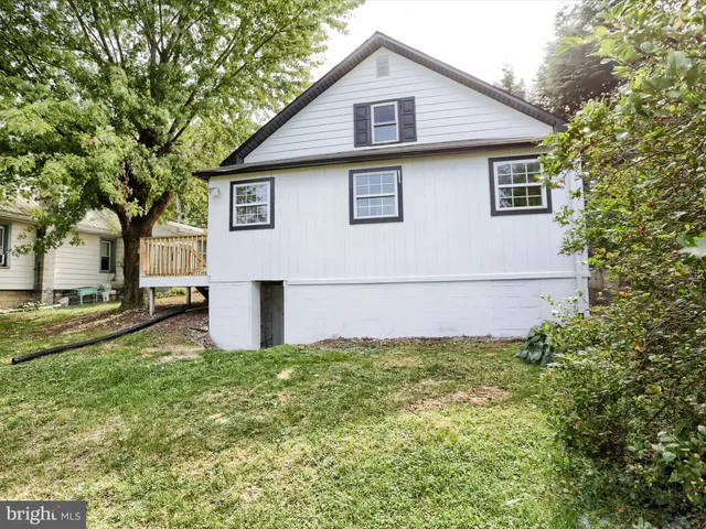 a picture of a room with a white wall and a picture