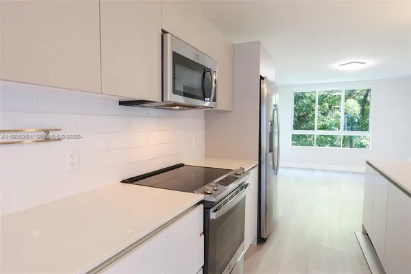 a kitchen with a stove and a microwave