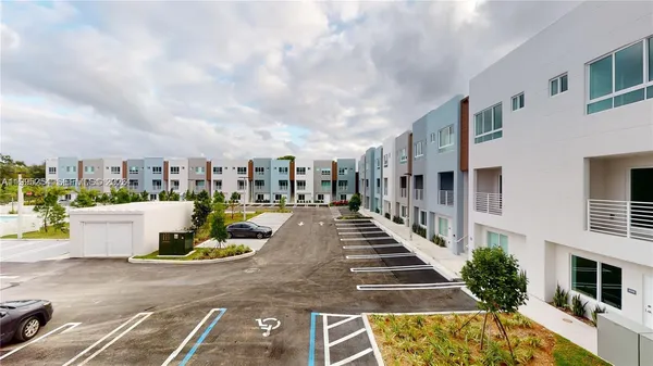 a front view of a building with a swimming pool