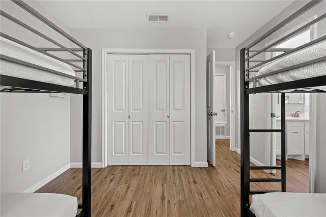 a view of a hallway with wooden floor and entryway