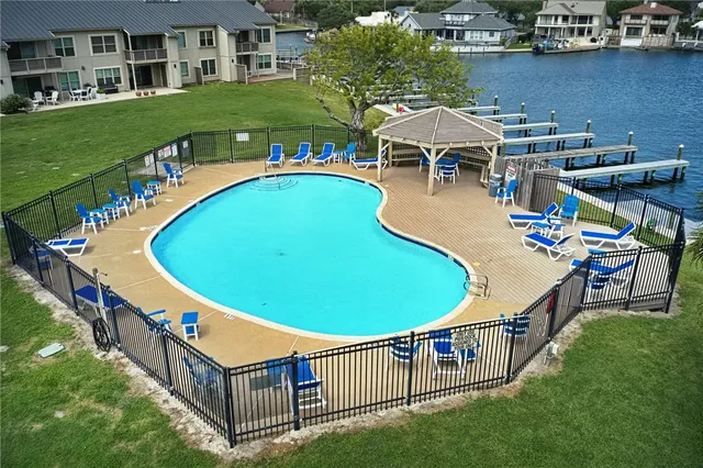 an aerial view of a house with outdoor space and swimming pool