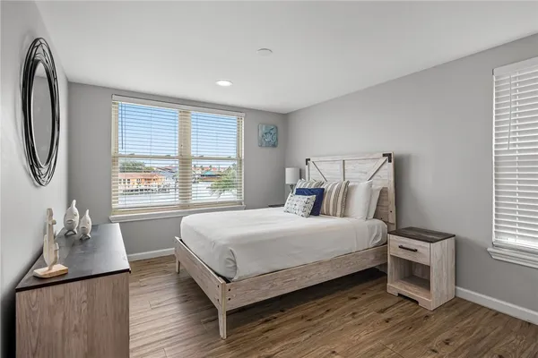 a bedroom with a bed and wooden floor