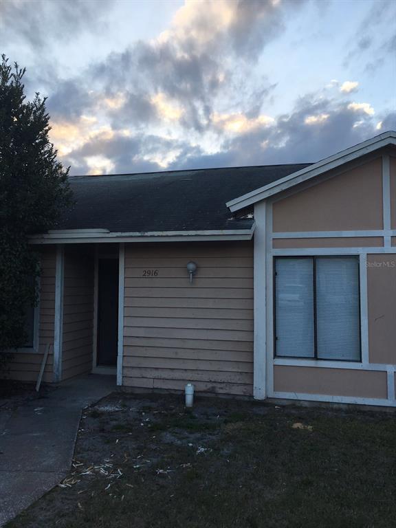 2916 Eastern Willow Avenue Orlando, FL 32808 - Photo 1 of 1 a backyard of a house with lots of green space