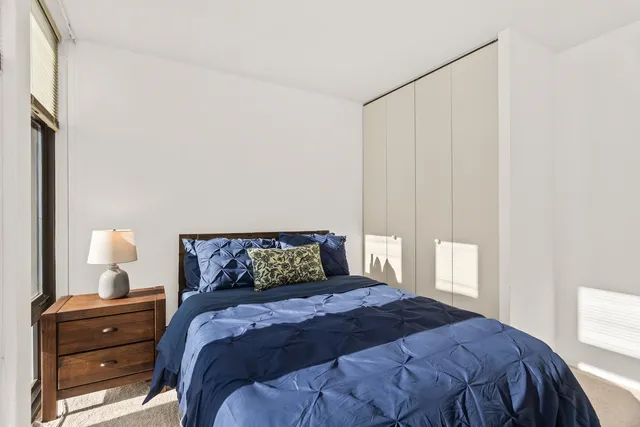 a bedroom with a bed and window