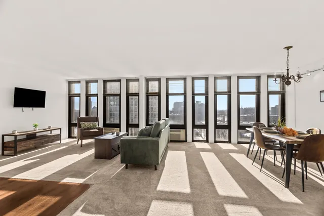 a living room with furniture tv and a table