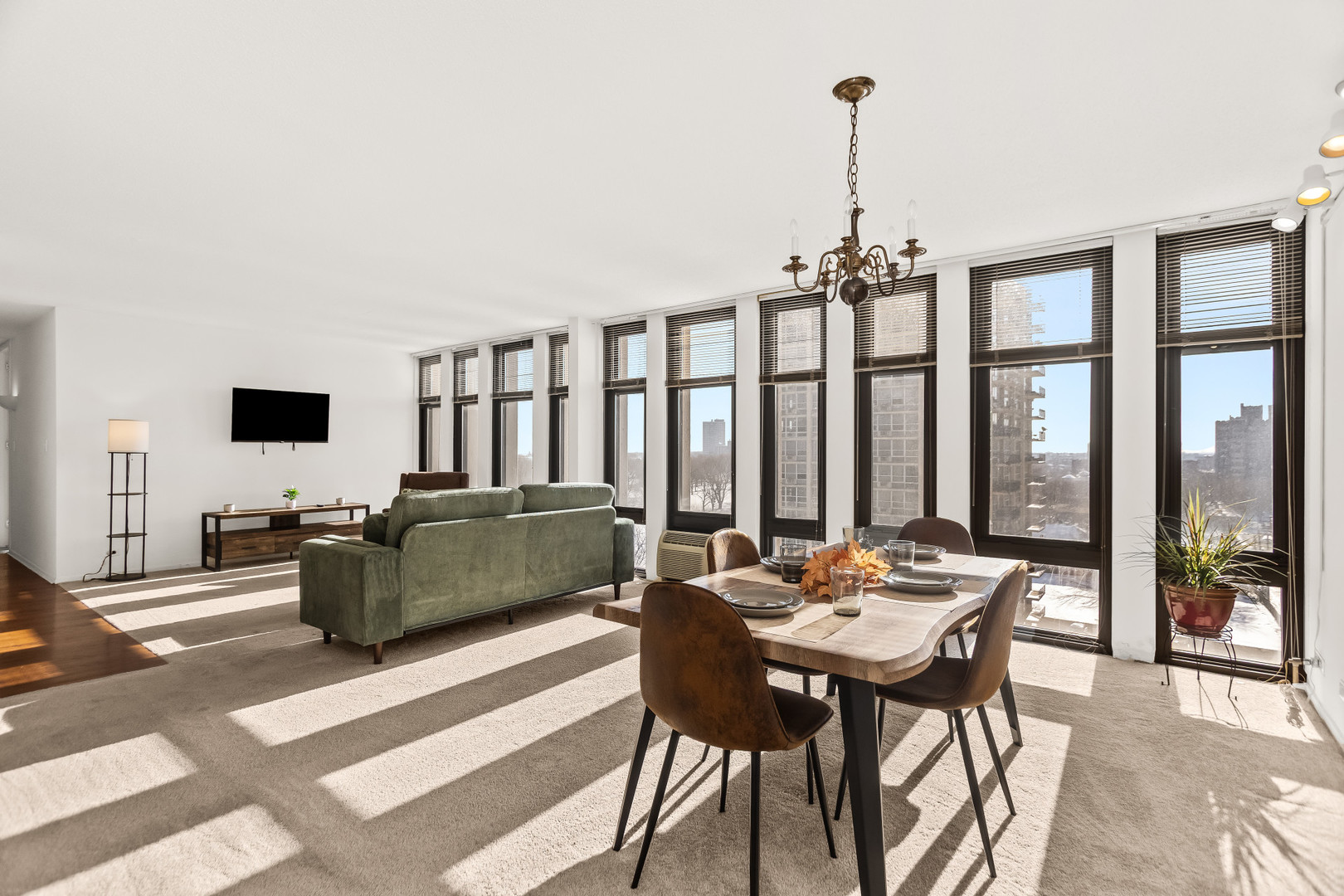 6700 South South Shore Drive, Unit 9D9E Chicago, IL 60649 - Photo 6 of 20 a living room with furniture and a flat screen tv