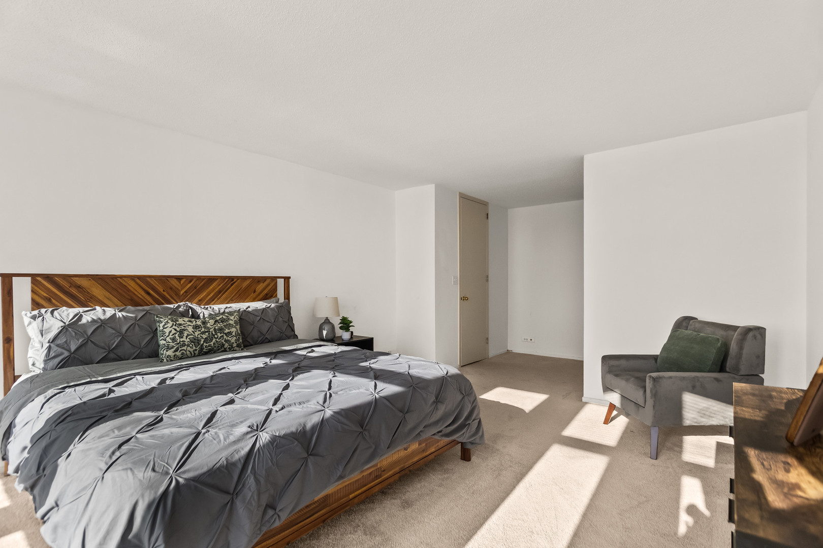 6700 South South Shore Drive, Unit 9D9E Chicago, IL 60649 - Photo 10 of 20 a bedroom with a bed and chair