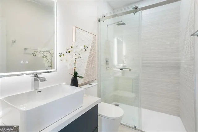 a bathroom with a sink toilet and shower