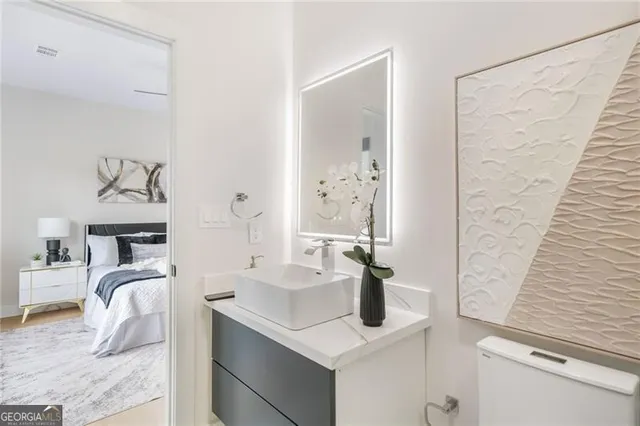 a bedroom with a bed and a table chair