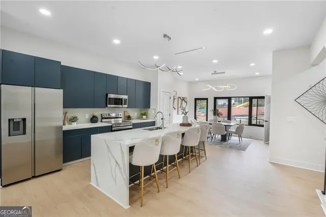 a kitchen with counter space appliances and a dining table
