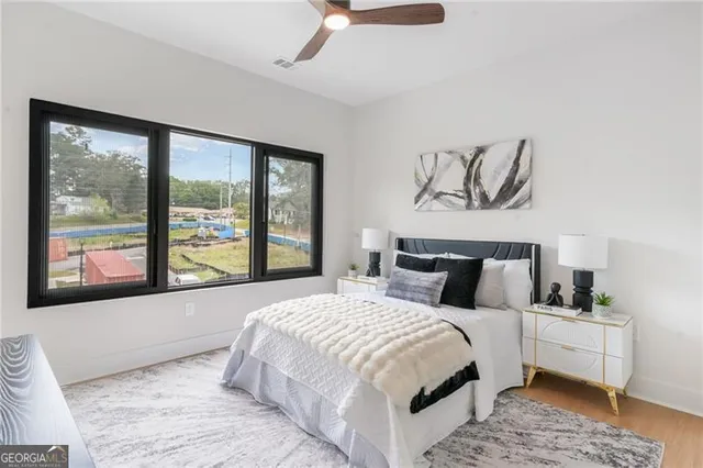 a bedroom with a large bed and a window