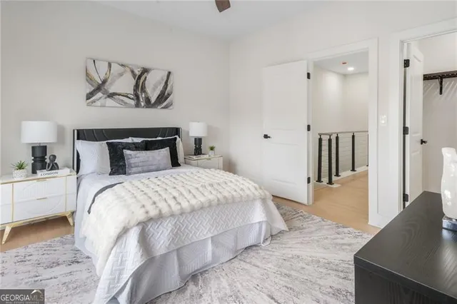 a bedroom with a large bed and a chandelier