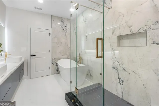 a spacious bathroom with a granite countertop sink a toilet and shower