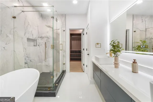 a bathroom with a tub sink and mirror