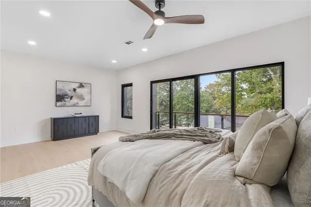 a bedroom with a large bed and a large window