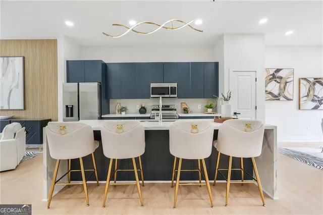 a dining table with chairs and kitchen island