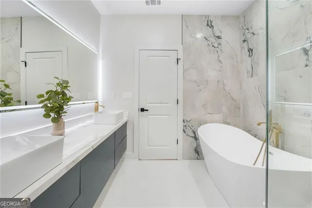 a bathroom with a granite countertop sink a toilet and shower