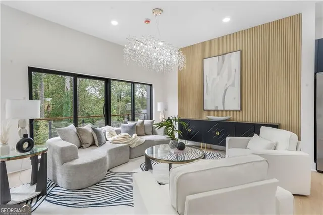 a living room with furniture and a chandelier
