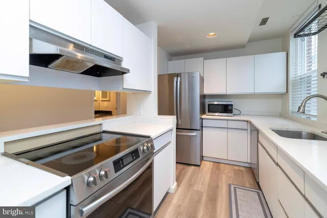 a kitchen with a stove and a refrigerator