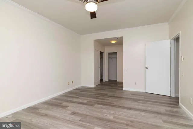 a view of an empty room with wooden floor