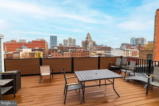 a view of a terrace with wooden benches