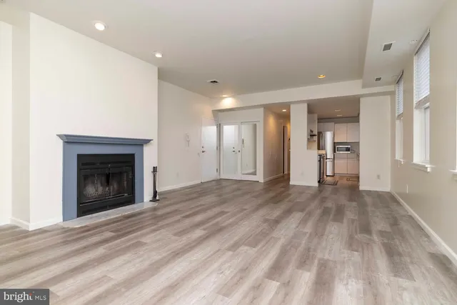 a view of an empty room with a fireplace