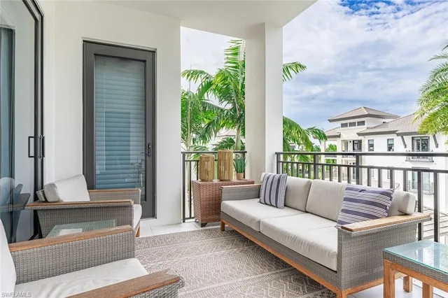 a balcony with furniture and a potted plant