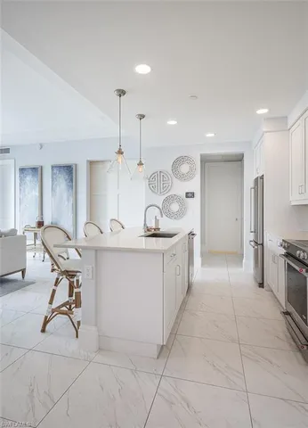 a large kitchen with a table and chairs