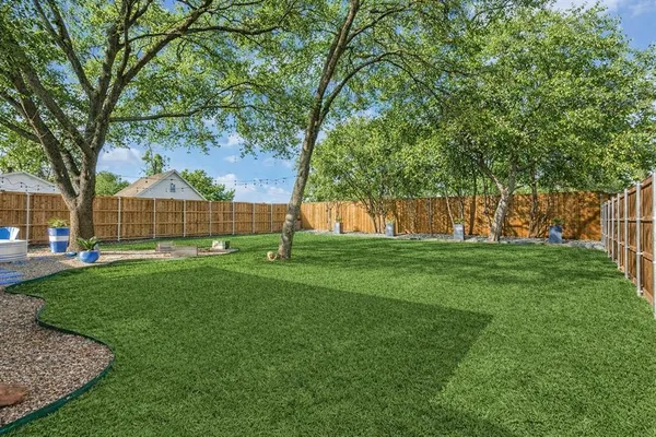 a view of yard with swimming pool and green space