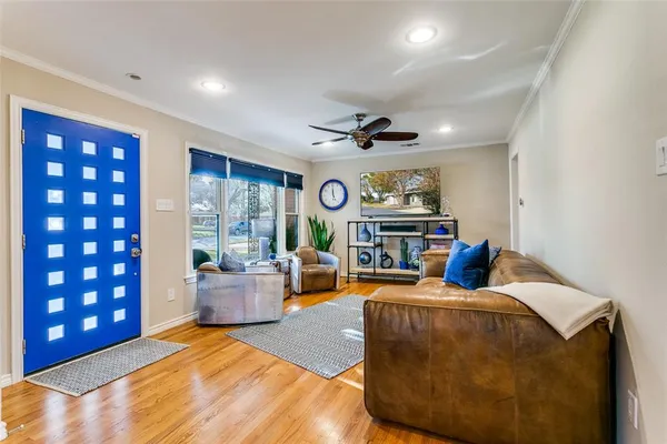 a living room with furniture kitchen view and a large window