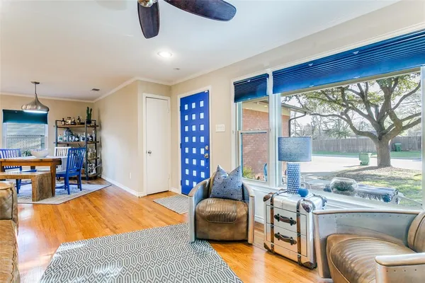 a bedroom with furniture and a large window