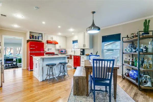 a living room with furniture and a kitchen view