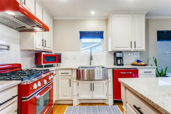 a kitchen with stainless steel appliances granite countertop a stove and a refrigerator