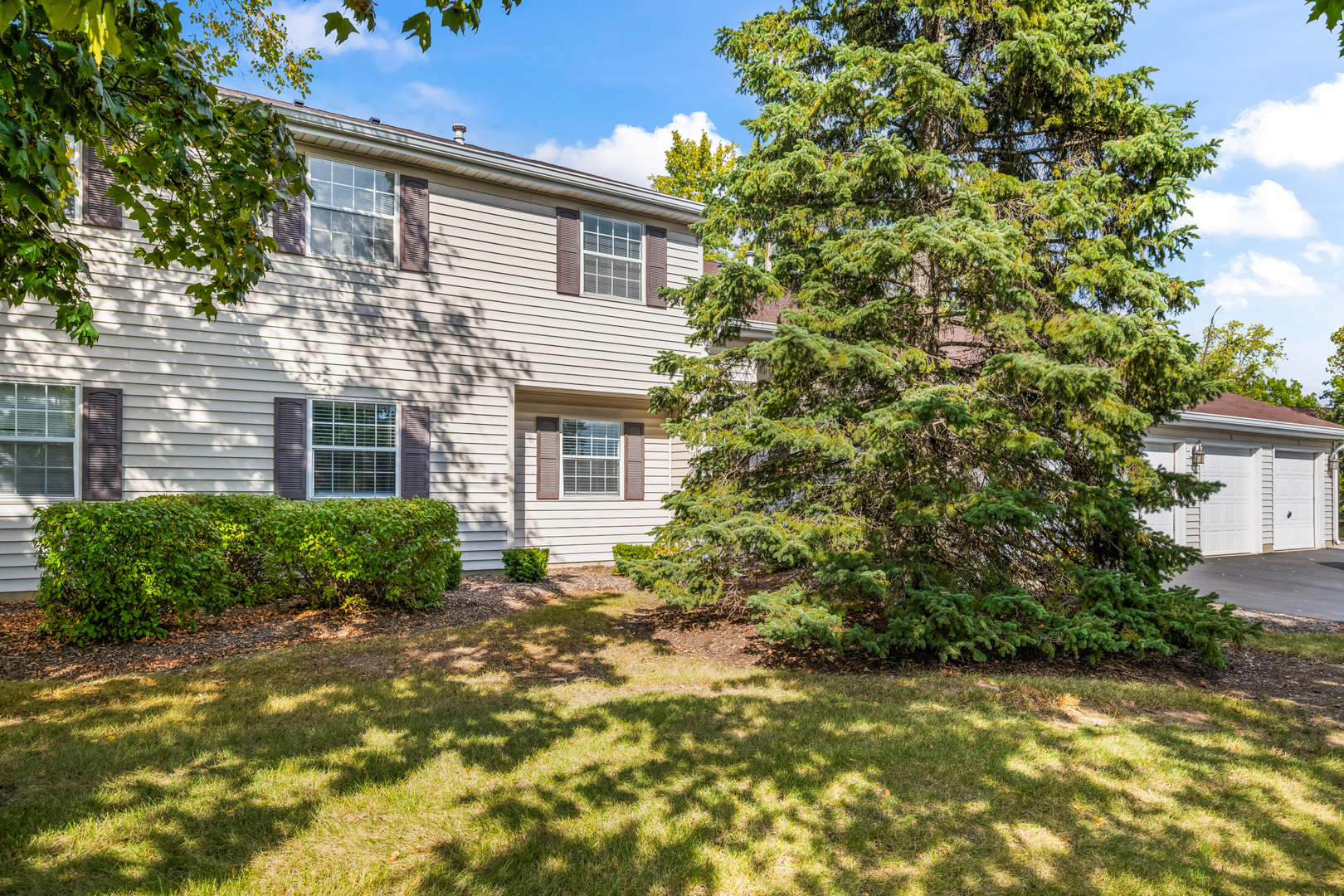 556 East Shag Bark Lane, Unit C Streamwood, IL 60107 - Photo 1 of 15 a view of a house with a tree