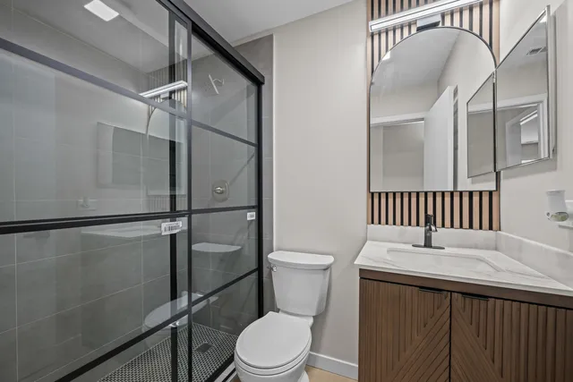 a bathroom with a toilet a sink and shower