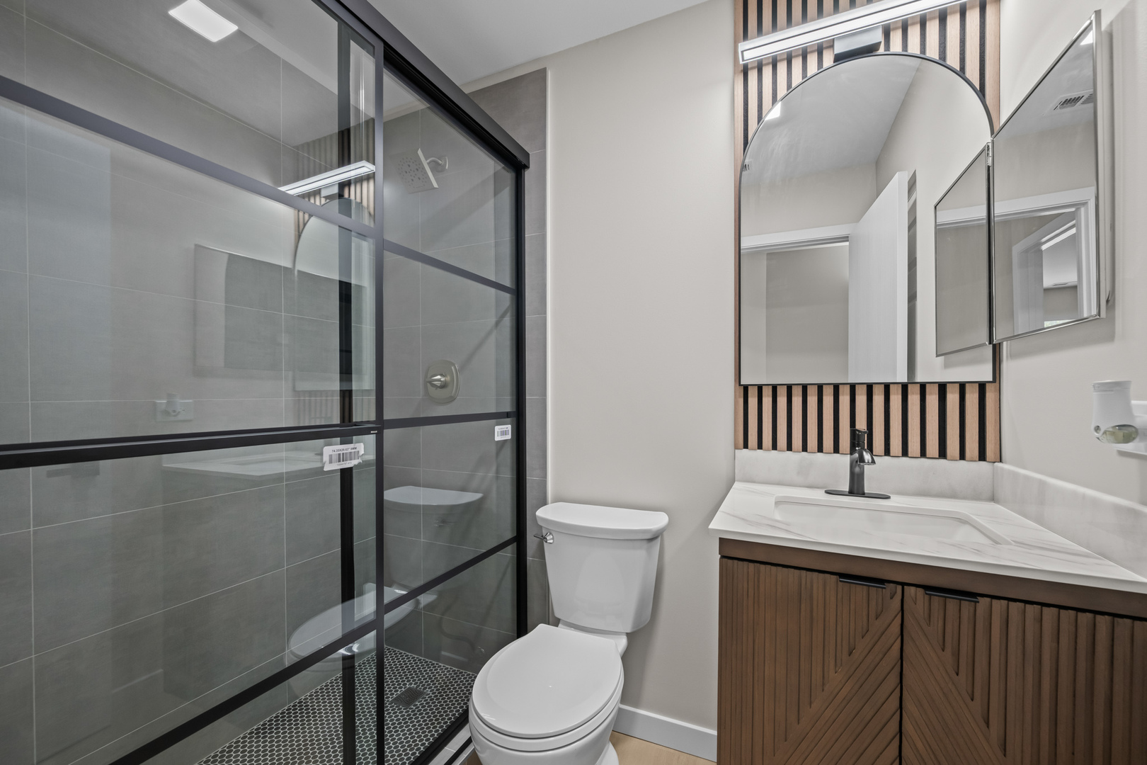 556 East Shag Bark Lane, Unit C Streamwood, IL 60107 - Photo 11 of 15 a bathroom with a toilet a sink and shower