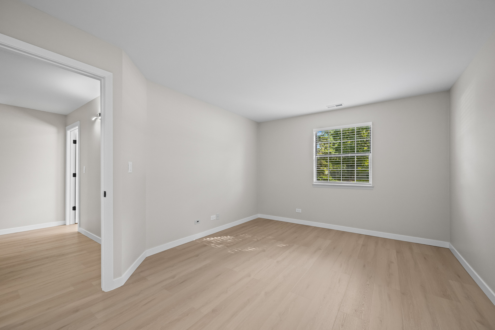 556 East Shag Bark Lane, Unit C Streamwood, IL 60107 - Photo 13 of 15 an empty room with a window