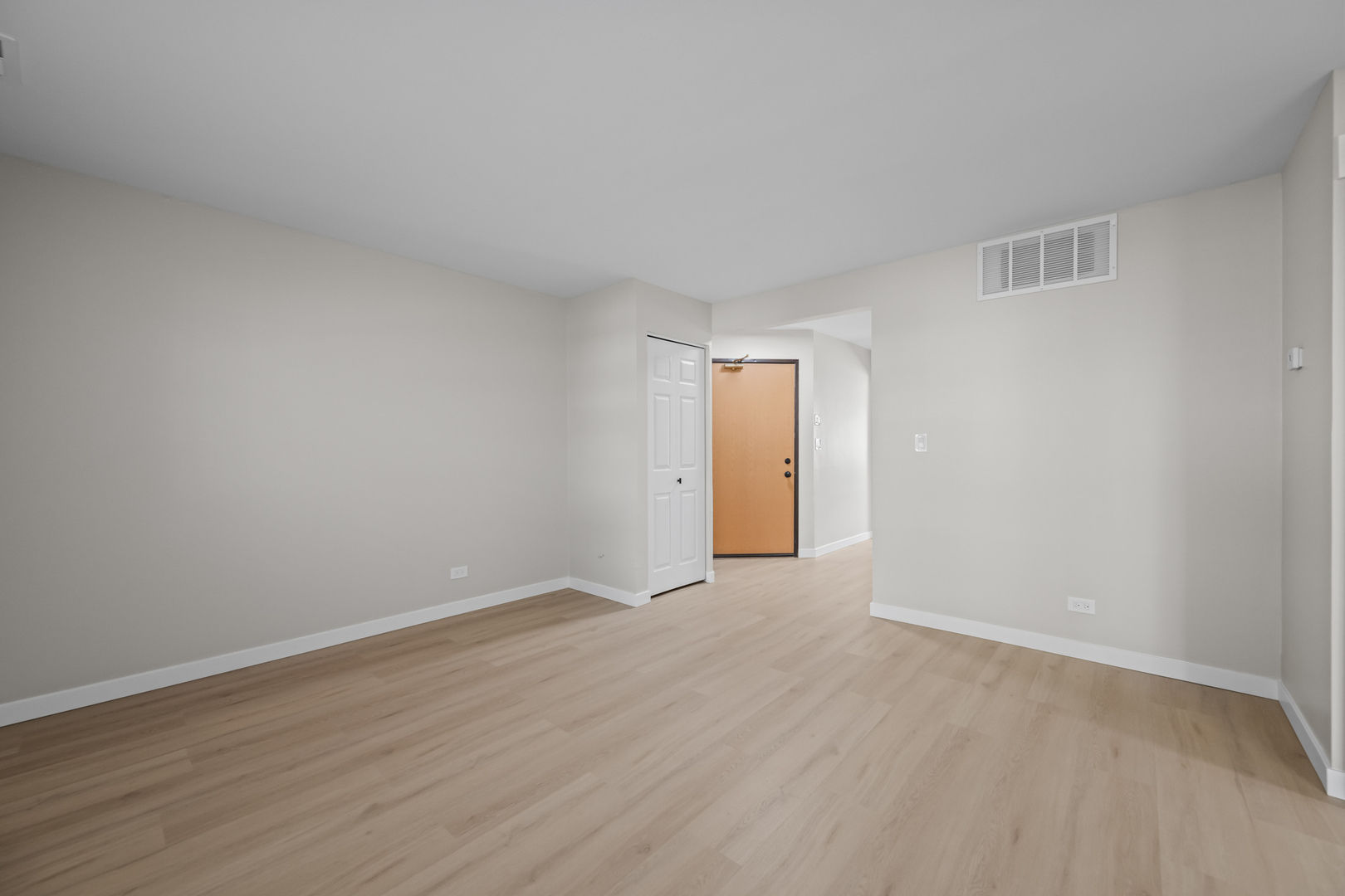 556 East Shag Bark Lane, Unit C Streamwood, IL 60107 - Photo 2 of 15 a view of an empty room and wooden floor