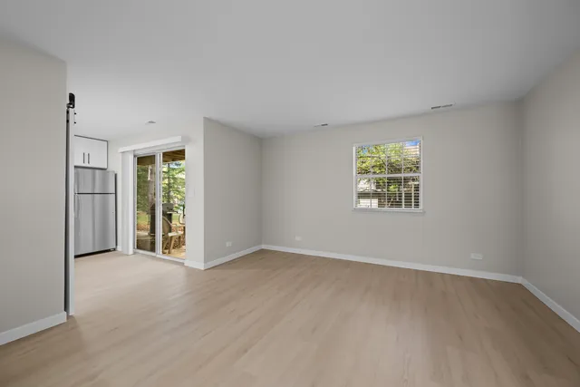 an empty room with windows and closet