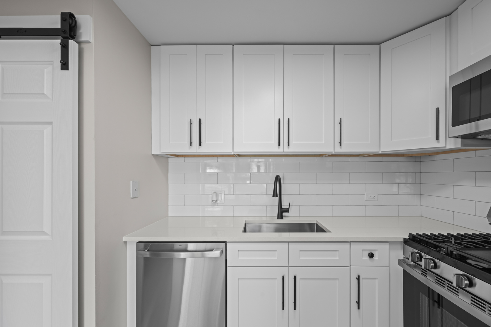 556 East Shag Bark Lane, Unit C Streamwood, IL 60107 - Photo 7 of 15 a kitchen with white cabinets and appliances