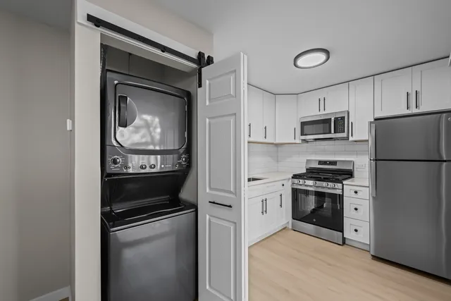 a kitchen with a refrigerator stove and microwave